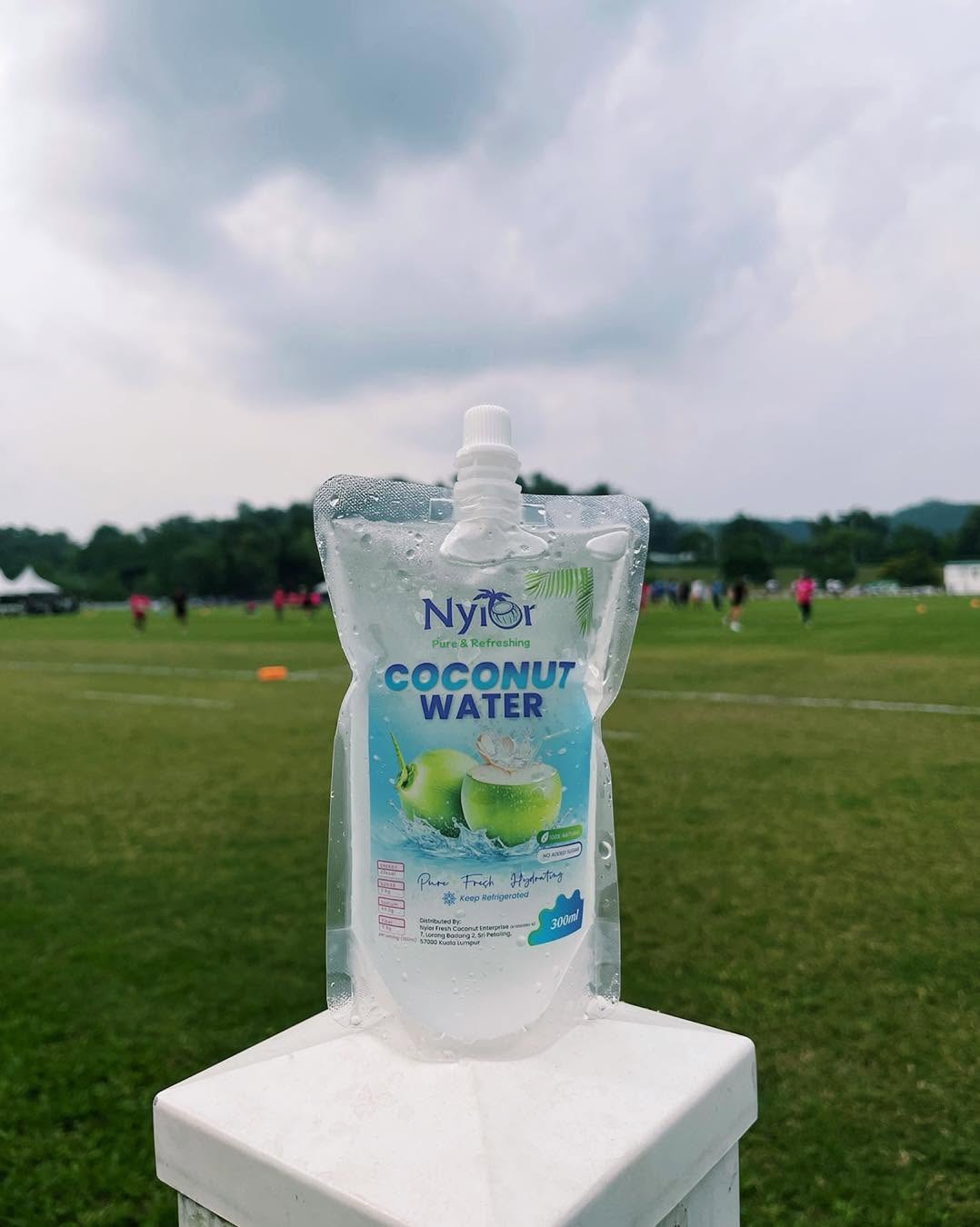 Nyior 300ml coconut water pouch, chilled and beaded with condensation